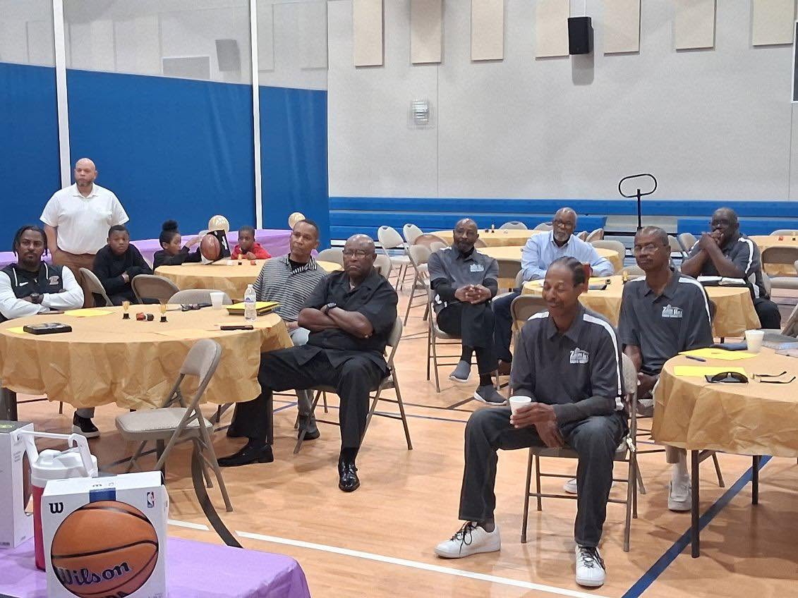 Community members participating in a fellowship event inside a gymnasium