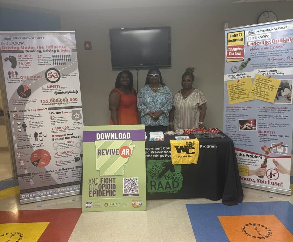 Prevention team at an educational outreach table with ReviveAR materials